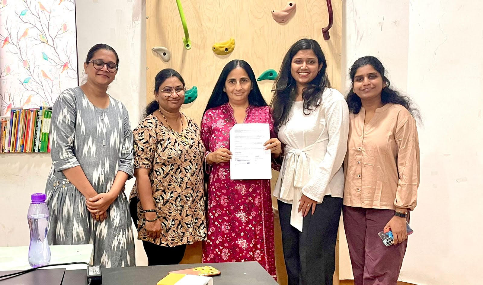 Special Hangout and SOLS ARC team members holding the signed partnership MOU
